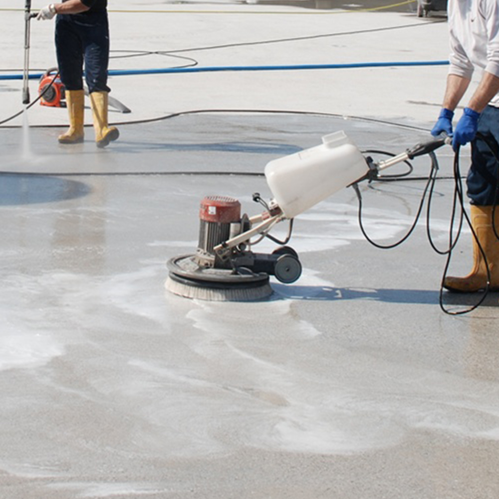 Degreasing and decontaminating a concrete floor with Degreaser and a floor machine