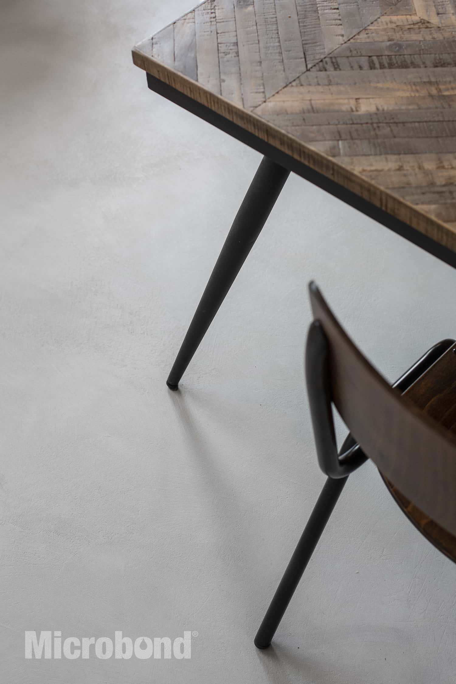 Close-up detail of a gray microcement kitchen floor